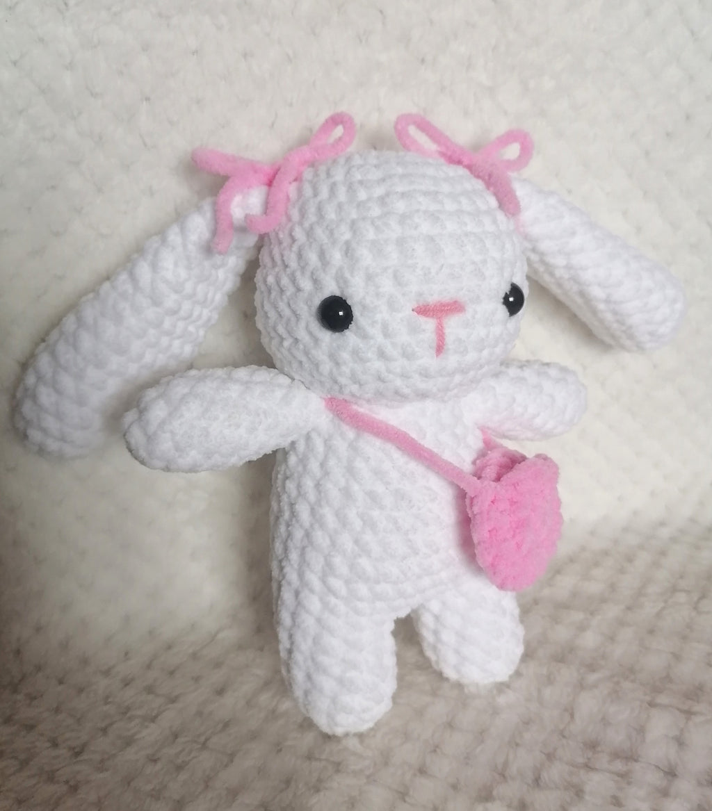 Lapin blanc avec sac rose